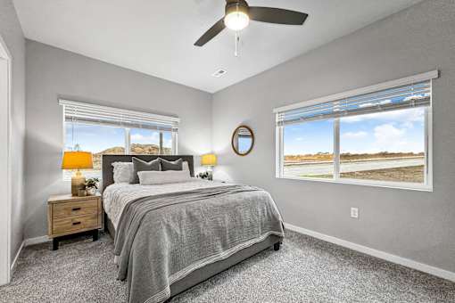 a bedroom with a bed and a ceiling fan at Converge NW, Waukee, 50263  