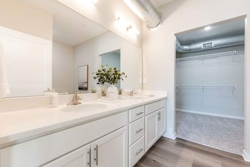 A bathroom with a white counter and a large mirror.at Converge NW, Waukee Iowa  