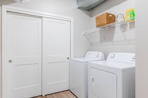 a white washer and dryer in a laundry room with white doors at Converge NW, Waukee  