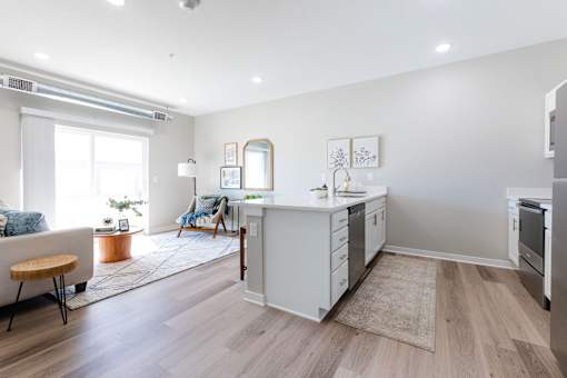 a living area with a kitchen and a living room at Converge NW, Iowa  