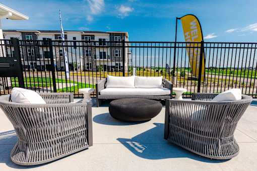 a lounge area with couches and chairs outside of a building at Converge NW, Waukee Iowa  