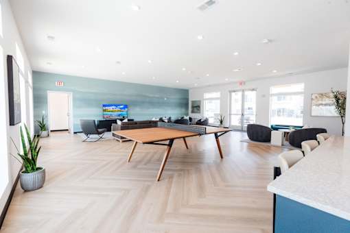 a living room with a wooden floor and a table and chairs at Converge NW, Iowa  