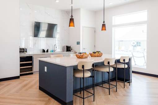 a kitchen with a large island and white and blue cabinets at Converge NW, Waukee, IA 50263  