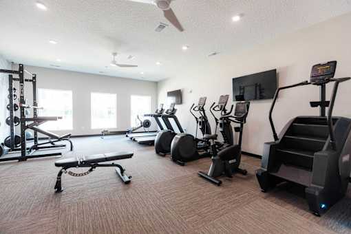 the gym is equipped with cardio equipment and weights at Converge NW, Waukee, IA 50263  