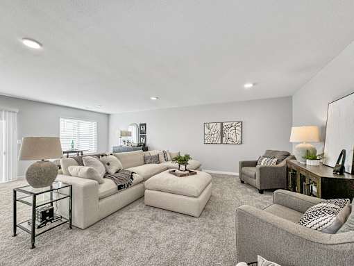 a living room with couches and chairs at Rialto Townhomes Apartments, Waukee