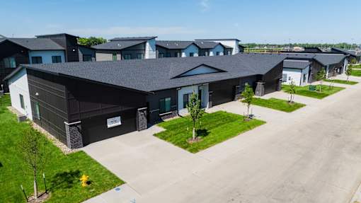an aerial view of a group of houses in a parking lot at Rialto Townhomes Apartments, Waukee, 50263
