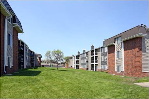an exterior view of an apartment complex with green grass at Penbrooke Place Apartments, Sioux Falls, SD, 57106