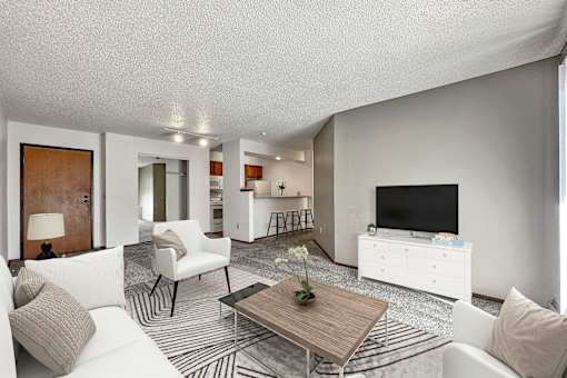 A living room with a white couch and a coffee table at Penbrooke Place Apartments, Sioux Falls, SD