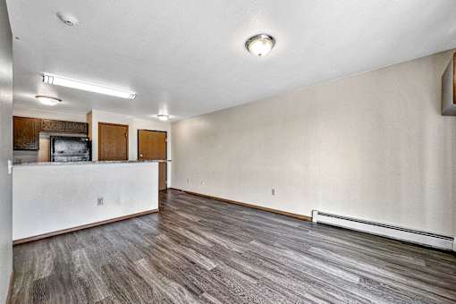 A room with wooden flooring and a white wall at Penbrooke Place Apartments, Sioux Falls, SD, 57106