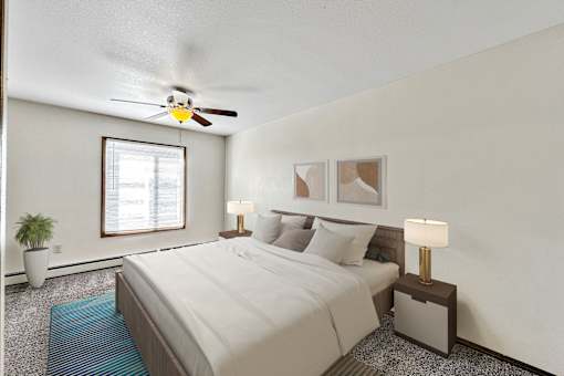 A bedroom with a bed, two lamps, a ceiling fan, and a potted plant at Penbrooke Place Apartments, South Dakota, 57106
