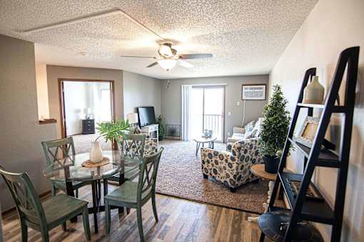 A living room with a glass table and chairs at Penbrooke Place Apartments, Sioux Falls, SD