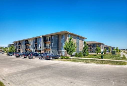 A large building with a parking lot in front of it.