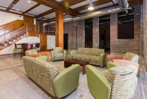 A room with a staircase and a couch.at Riverpoint Lofts, Des Moines, 50309  