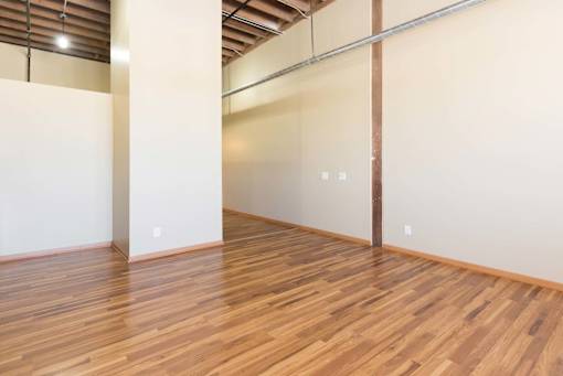 A room with wooden flooring and white walls.at Riverpoint Lofts, Des Moines  