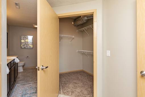an open bathroom door looking into a bathroom with a shower and a toilet at Lake Shore Apartments, Ankeny