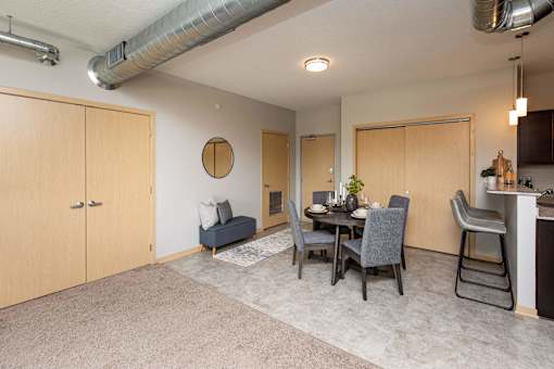 a dining room and living room with a table and chairs at Lake Shore Apartments, Iowa