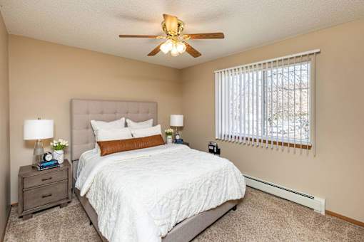 a bedroom with a bed and a ceiling fan at Lake Shore Park, Ankeny
