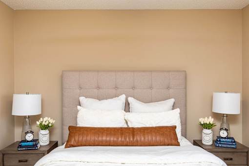 a bedroom with a bed and two nightstands with lamps at Lake Shore Park, Ankeny