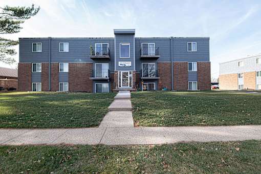 A large apartment complex with a grassy front yard at Lake Shore Place Apartments, Ankeny, IA,  50021