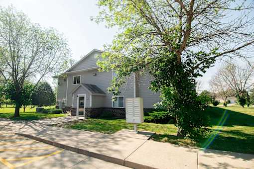 A house with a driveway and a sign in front of it at Peach Tree Apartments, Ankeny, IA,  50021