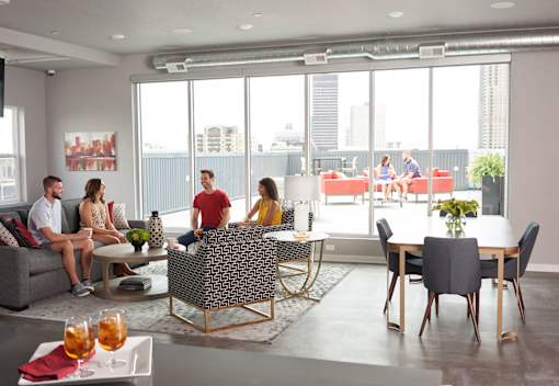 a group of people sitting in a living room at Vue Apartments, IA, 50309