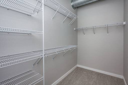 spacious closet with shelves and racks at theria apartments at Vue Apartments, Des Moines