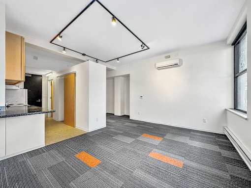 A room with a grey carpet and a white wall at The Des Moines Building Apartments, Iowa, 50309