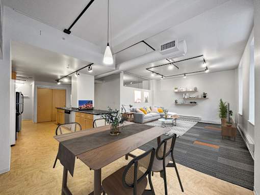 A modern kitchen with a dining table and chairs at The Des Moines Building Apartments, Des Moines, IA, 50309
