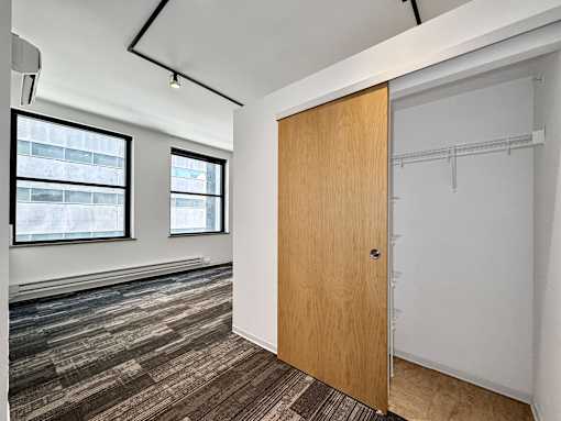 A room with a wooden door and a window at The Des Moines Building Apartments, Iowa