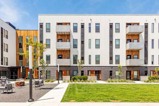a building with a lawn in front of it at Rowat Lofts, Des Moines, IA  