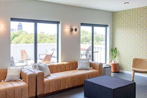 a living room with a couch and a table at Rowat Lofts, Iowa, 50309