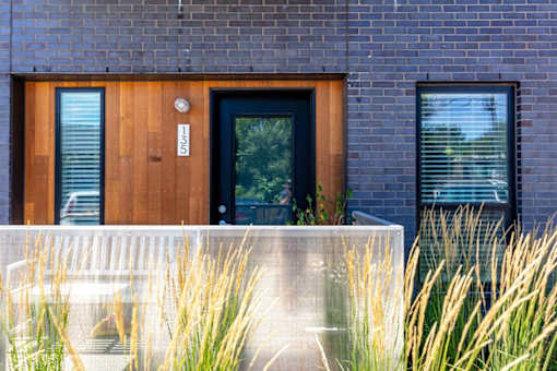 the front of a brick house with a wooden door at Rowat Lofts, Iowa, 50309