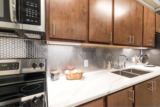 Kitchen Designed With Ample Storage Space at Clemens Building, Des Moines