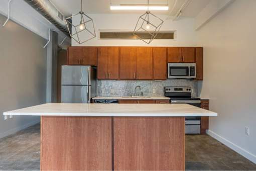 Kitchen with wooden cabinets and a white countertop at Clemens Building, Iowa