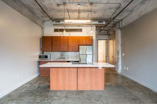 Kitchen with wood cabinets and stainless steel appliances at Clemens Building, Des Moines, IA, Iowa , 50309