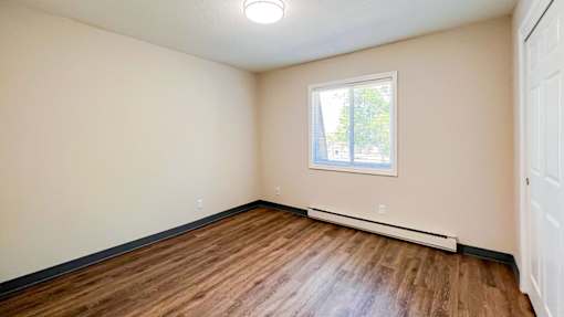 A room with a window and a white door at The Hampton Meadows Apartments,Des Moines, Iowa