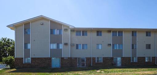 A long building with a lot of windows and doors at The Ridges Apartments, Des Moines, Iowa