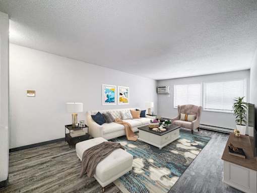 A living room with a white couch, a coffee table, and a television at The Ridges Apartments, Des Moines, IA,  50315
