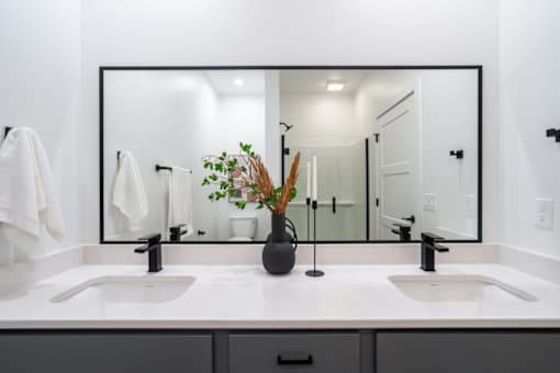 a bathroom with two sinks and a large mirror at Matilda 235 Townhomes, Des Moines, IA