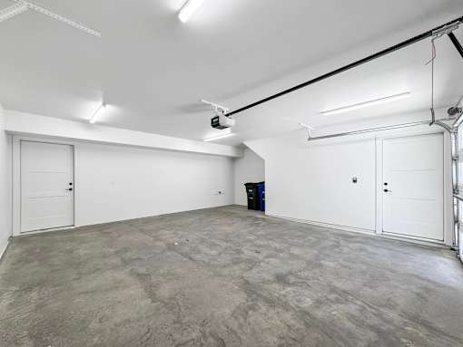 the interior of a garage with white walls and a concrete floor at Matilda 235 Townhomes, Des Moines