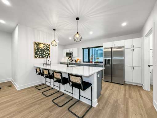 a kitchen with a large island and a stainless steel refrigerator at Matilda 235 Townhomes, Des Moines, 50309