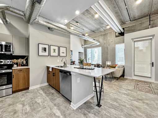 A kitchen with a large island and a dining table.at Level, Iowa, 50309