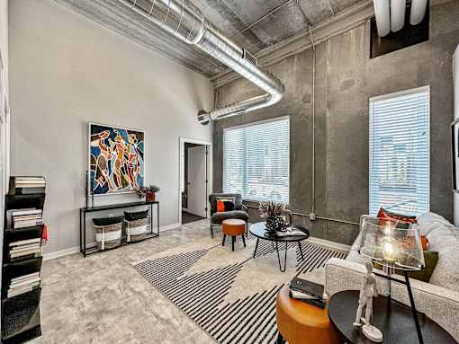 A living room with a large painting on the wall and a striped rug on the floor.at Level, Iowa, 50309