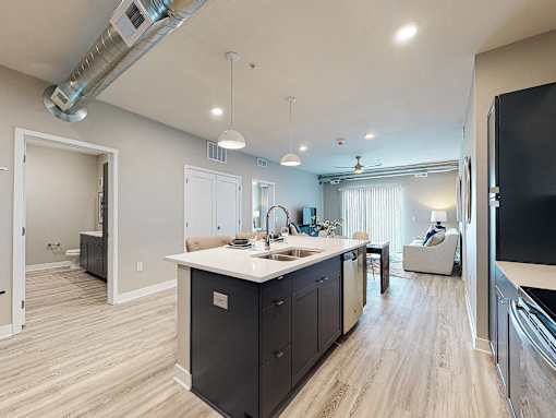 a kitchen with an island and a living room with a couch at Linc, Iowa, 50309