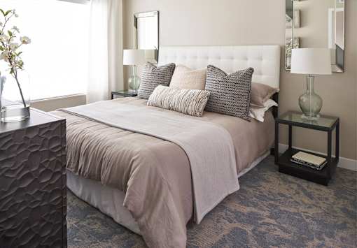 a bedroom with a bed and pillows at Linc, Des Moines  