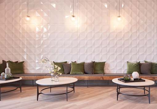 a seating area with tables and pillows at Linc, Des Moines  