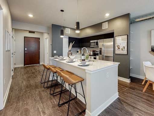 a kitchen with a large island with three stools at Linc, Iowa   