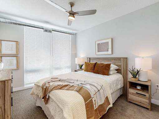 a bedroom with a bed and a ceiling fan at Linc, Des Moines Iowa   