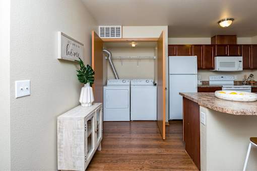 a kitchen with white appliances and a counter top at Melbourne Apartments, Des Moines, Iowa
