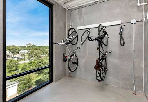 a room with two bikes hanging on the wall and a large window at Eagle View Lofts, Des Moines, IA, 50309